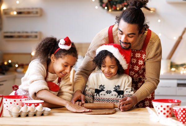 Dad making Christmas cookies with his son and daughter