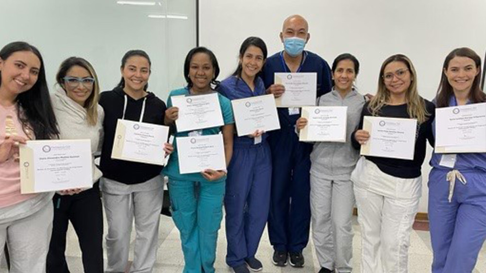 group of doctors holding diplomas.