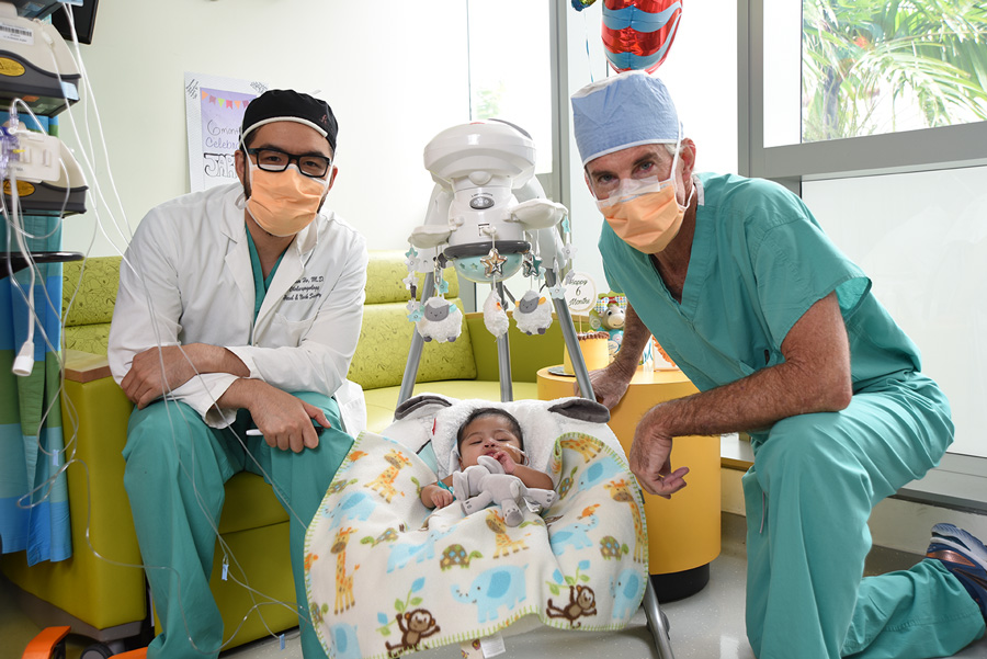 Dr. Ho, baby jarel in his crib, and Dr. Burke