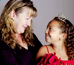 Alexis wearing a red dress and tiara next to her mom.