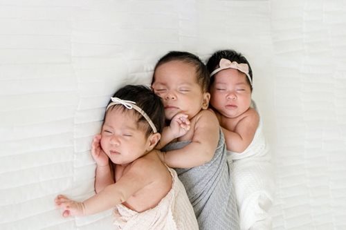 The triplets laying together
